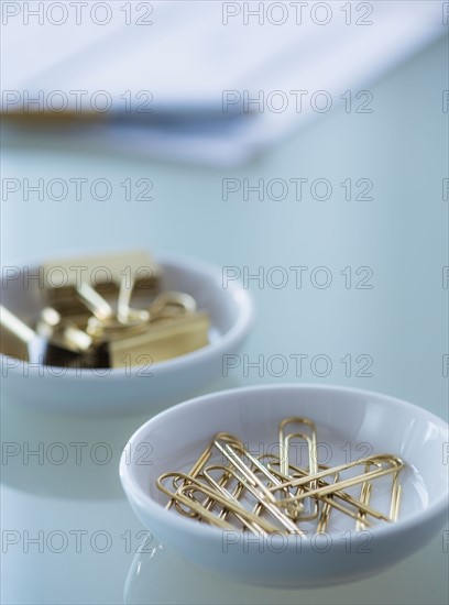 Close-up of paper clip and binder clip