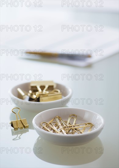 Close-up of paper clip and binder clip