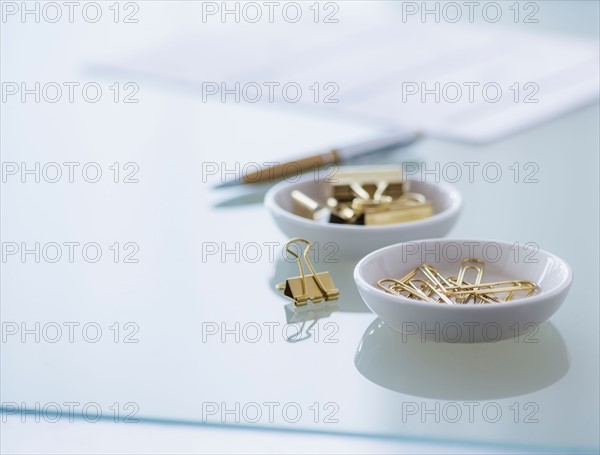 Close-up of paper clip and binder clip