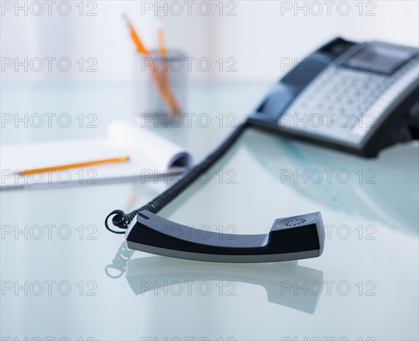 View of telephone and paper material on desk