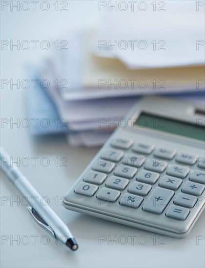 Studio Shot of calculator, pen and paper material