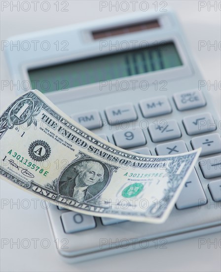 Studio Shot of one dollar bill and calculator