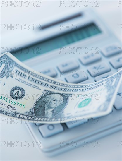 Studio Shot of one dollar bill and calculator