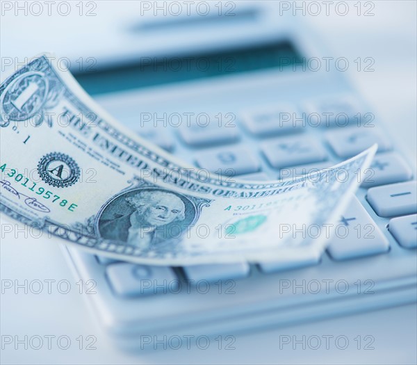 Studio Shot of one dollar bill and calculator