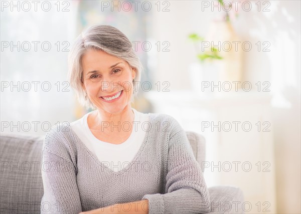 Portrait of woman relaxing on sofa