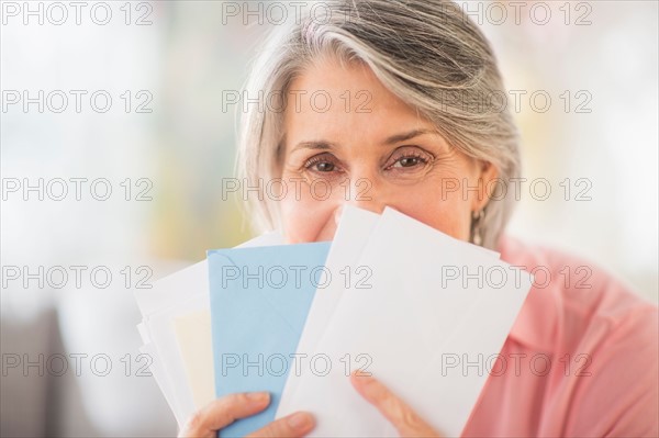 Portrait of woman holding mail