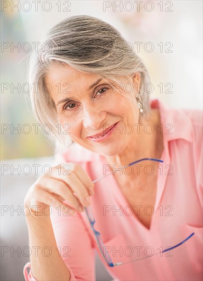 Portrait of woman holding glasses