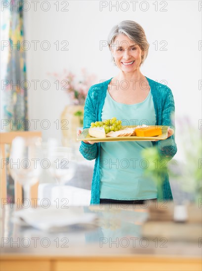 Portrait of woman holding appetizer plate