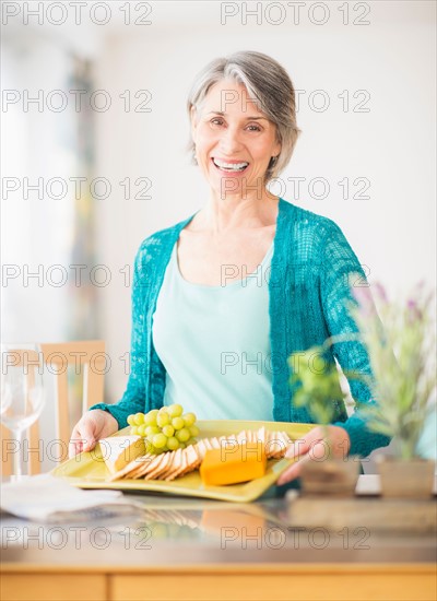 Portrait of woman holding appetizer plate