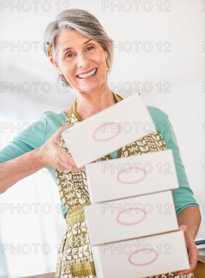 Portrait of woman carrying boxes