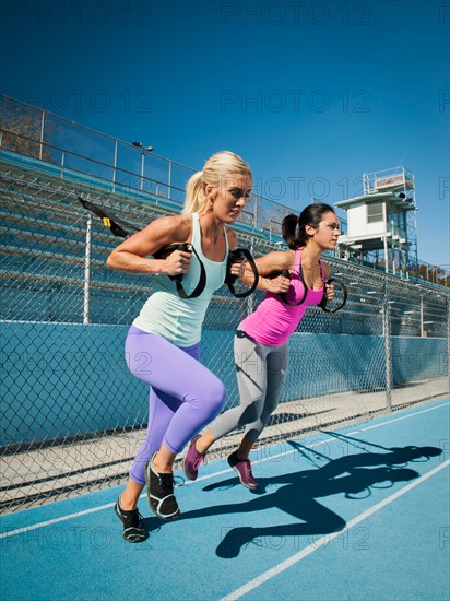 Two women using resistance band during exercise