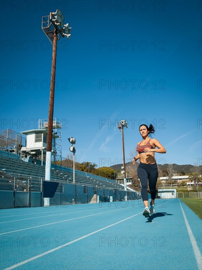 Woman running at sports field