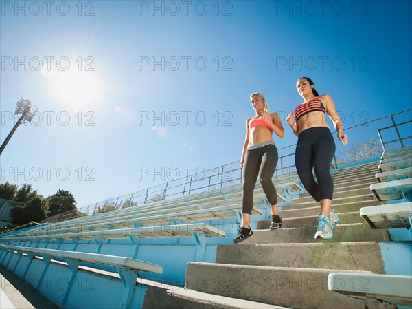 Two women walking down steps