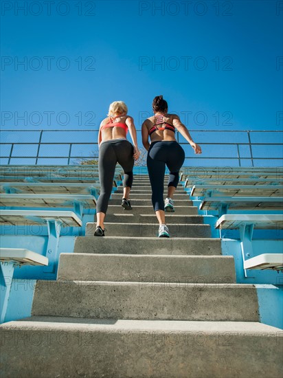Two women walking up steps
