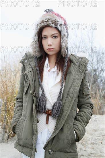 Portrait of young woman in warm clothes