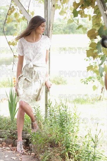 Portrait of woman in dress in garden