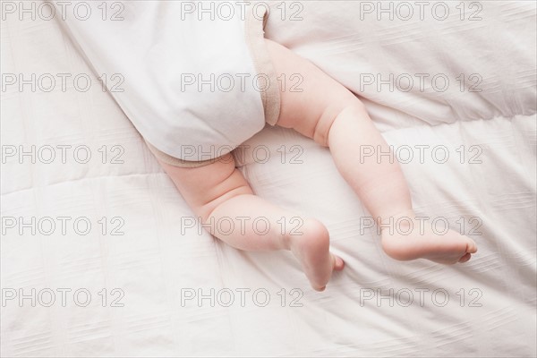 Low section of baby boy (18-23 months) lying on front