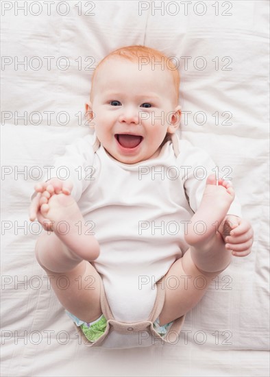 Directly above portrait of baby boy (18-23 months) lying down