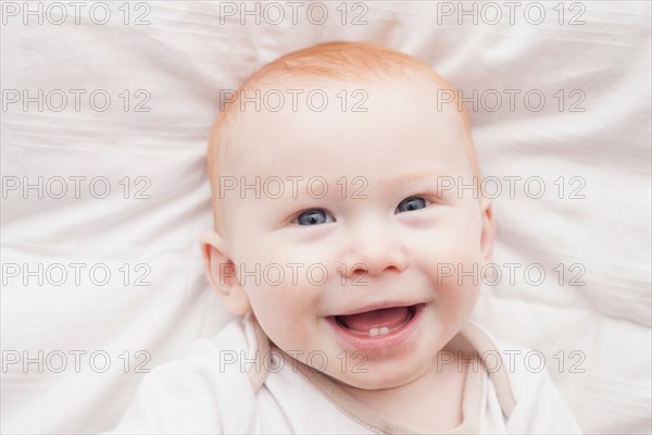 Portrait of baby boy (18-23 months) laughing