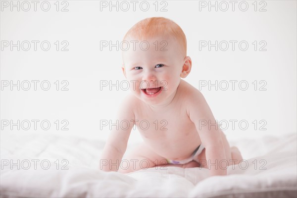 Portrait of baby boy (18-23 months) laughing