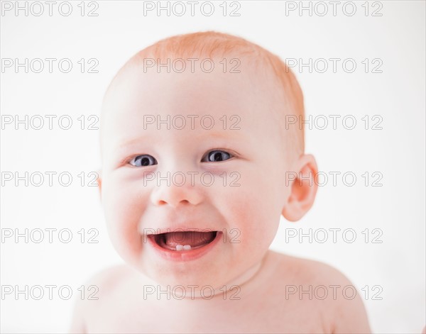 Studio shot portrait of laughing baby boy (18-23 months)