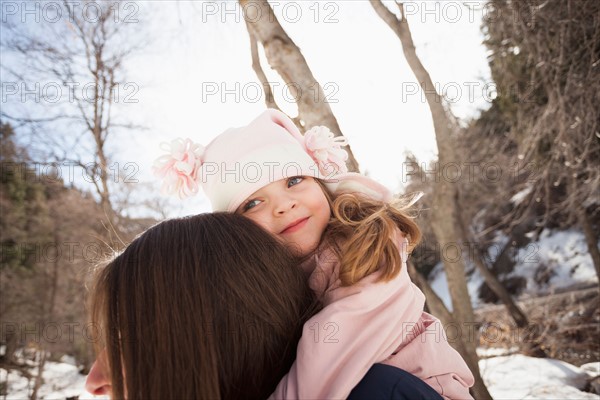 Girl (2-3) hugging her mother