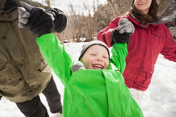 Boy (4-5) with parents during stroll