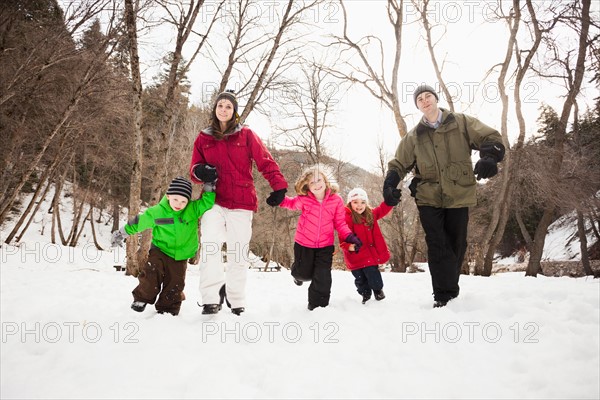 Three children (2-3, 4-5) with parents during stroll