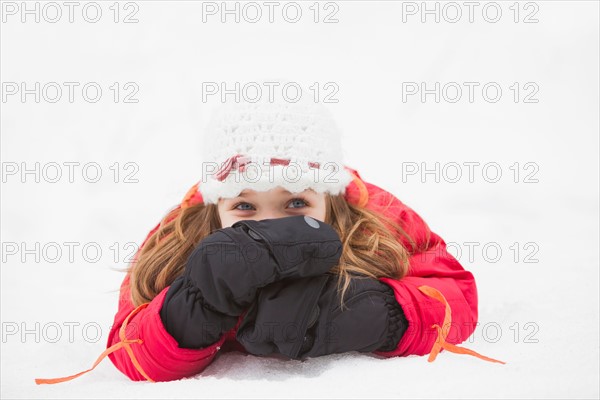 Portrait of girl (2-3) lying on snow