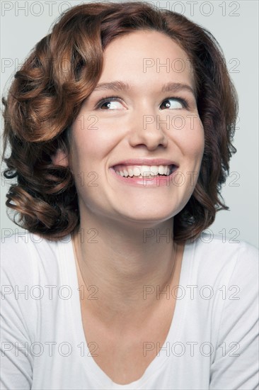 Studio shot portrait of young woman in white blouse