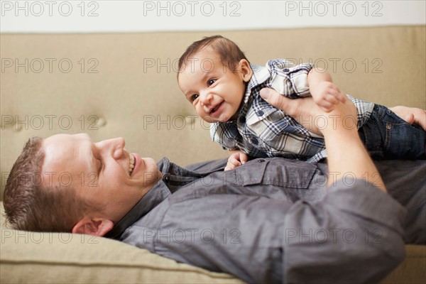 Father holding his son (2-5months)