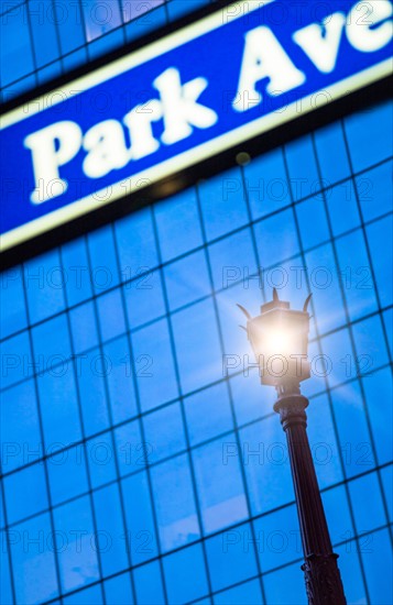 Detail of Park Avenue sign with street lamp. New York City, New York.