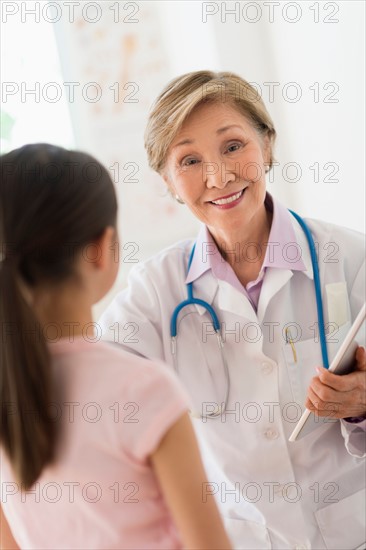 Portrait of doctor and girl (8-9) in foreground.