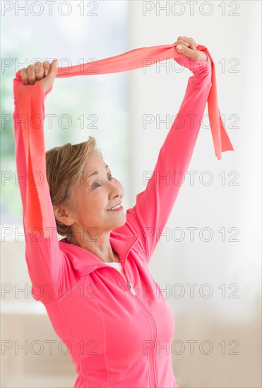 Senior woman exercising with exercise band.