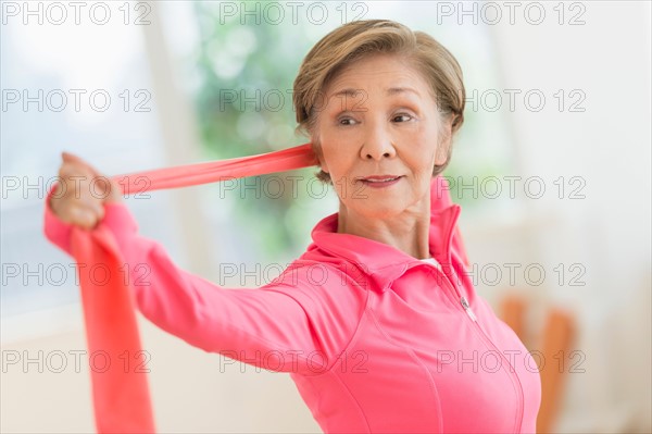 Senior woman exercising with exercise band.