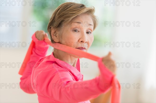 Senior woman exercising with exercise band.