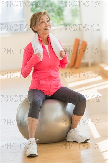 Senior woman exercising with fitness ball.