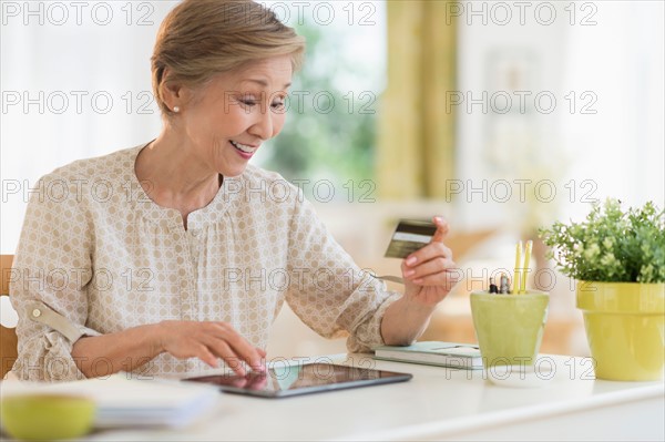 Senior woman shopping online with tablet pc.