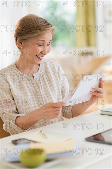 Senior woman reading letter.