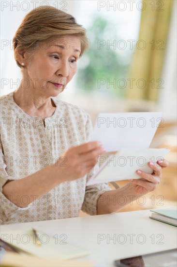 Senior woman reading letter.