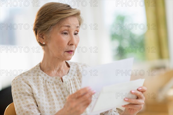 Senior woman reading letter.