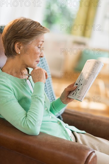 Senior woman doing crossword puzzle.