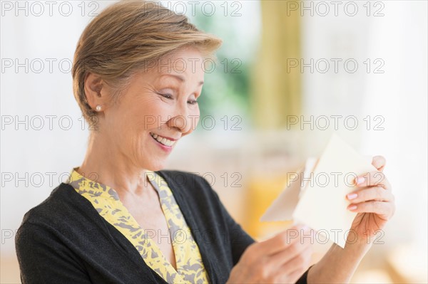 Senior woman reading note.