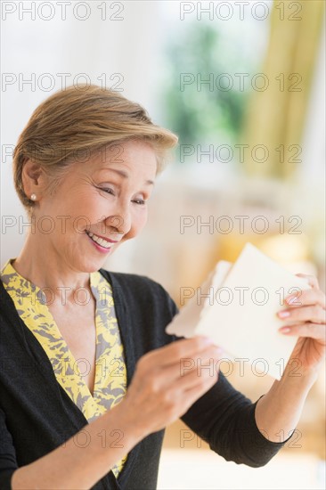 Senior woman reading note.