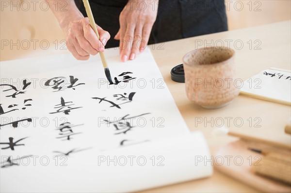 Female hands and japanese calligraphy.