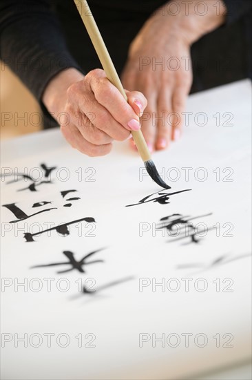 Female hands and japanese calligraphy.