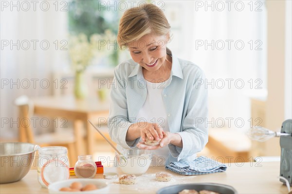 Senior woman cooking in kitchen.