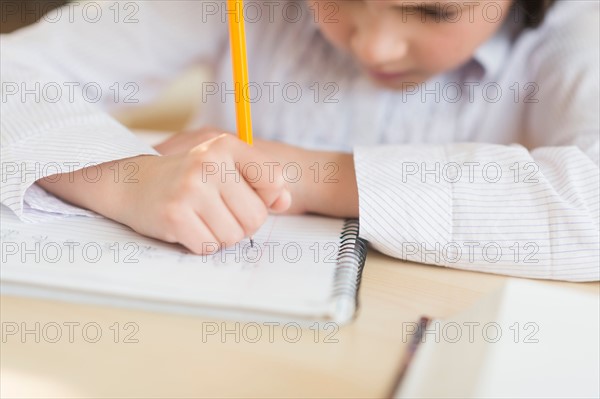 Girl (8-9) doing homework.