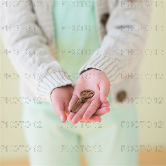 Girl (8-9) holding key.