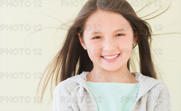 Girl (8-9) smiling, portrait.
